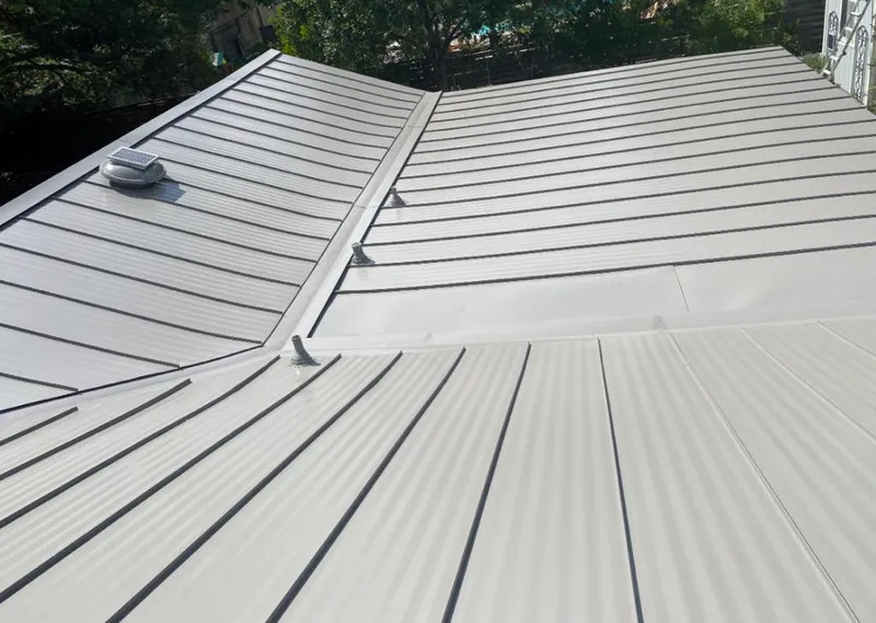 Solar attic fan installed on a metal roof for Roof Ventilation in Carrboro